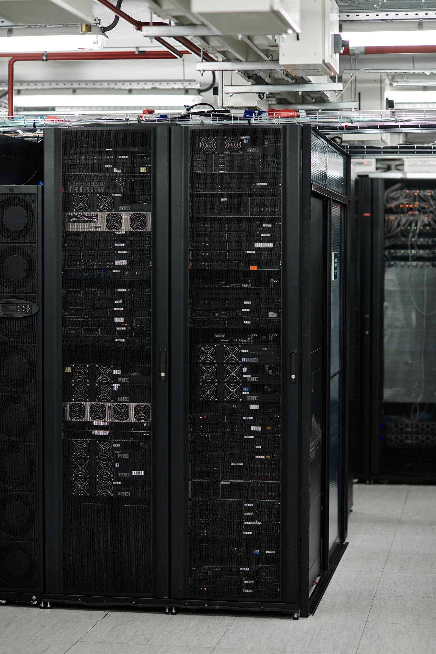 Server racks and overhead cabling in a live data center, the build-to-operate environment Clear staffs across the UK