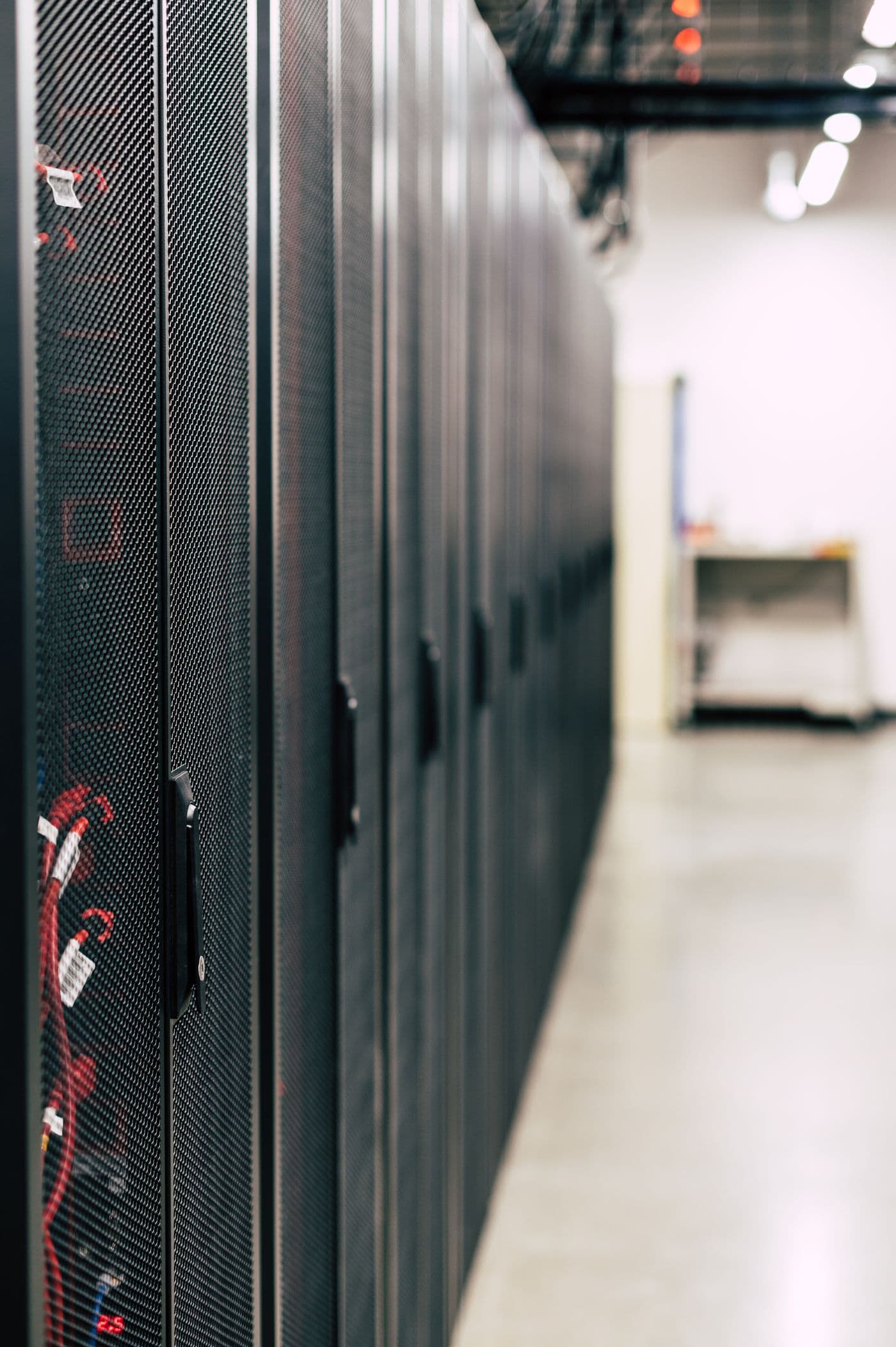 Row of server cabinets in a US data center hall, the mission-critical environment Clear recruits for