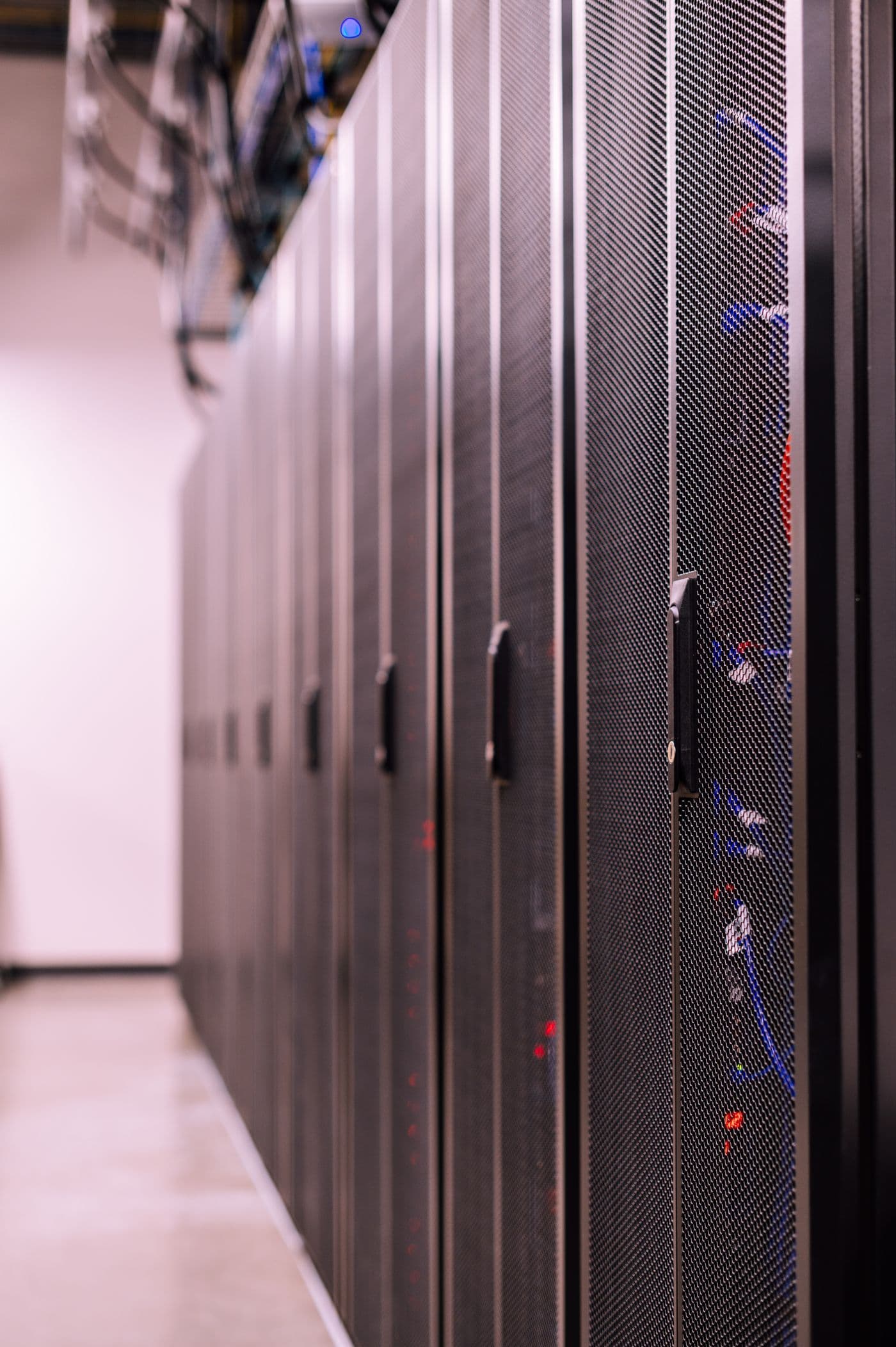 Cabinets and structured cabling in a US data center hall spanning construction handover into live operation