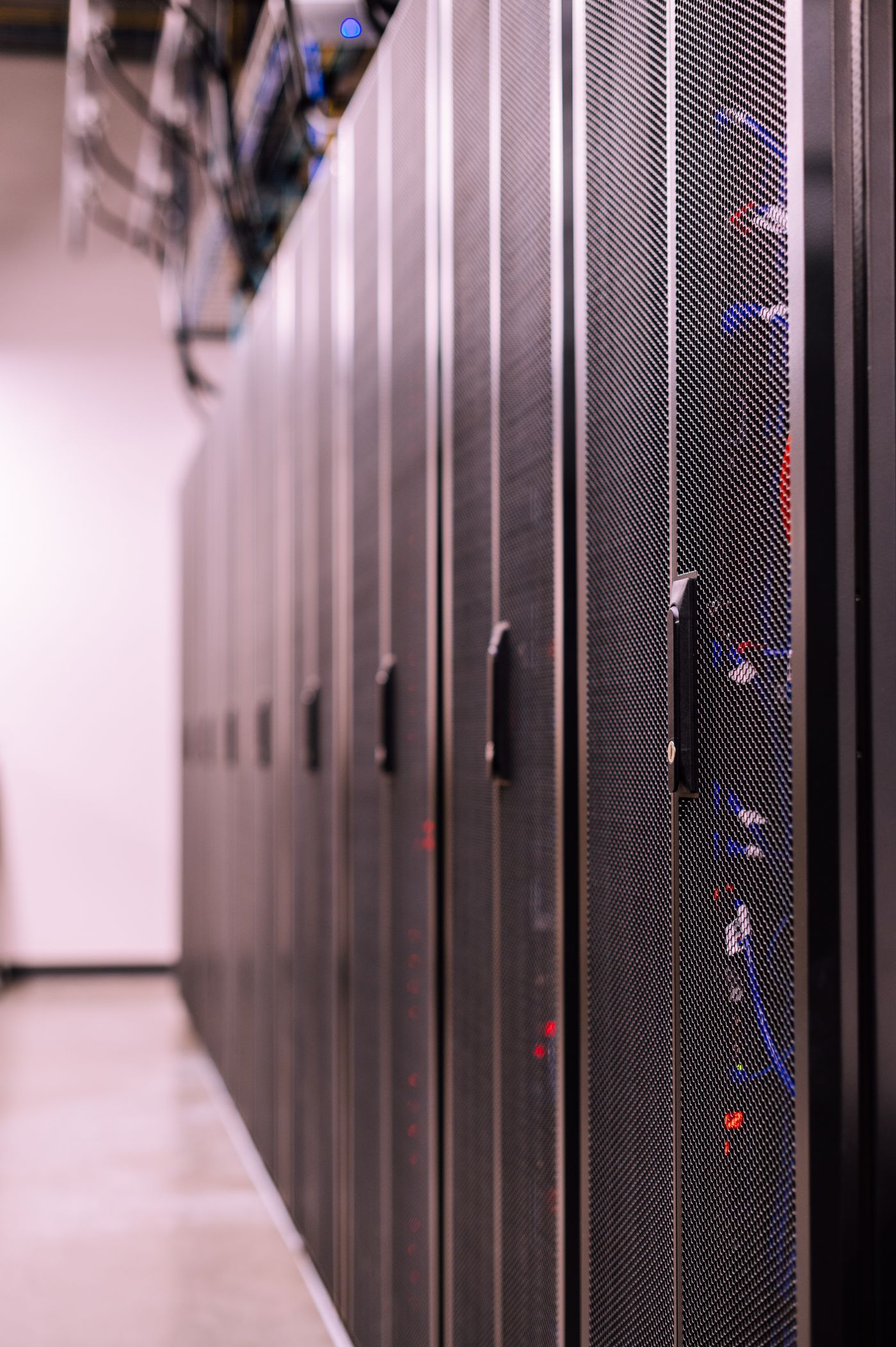 Cabinets and structured cabling in a US data center hall spanning construction handover into live operation